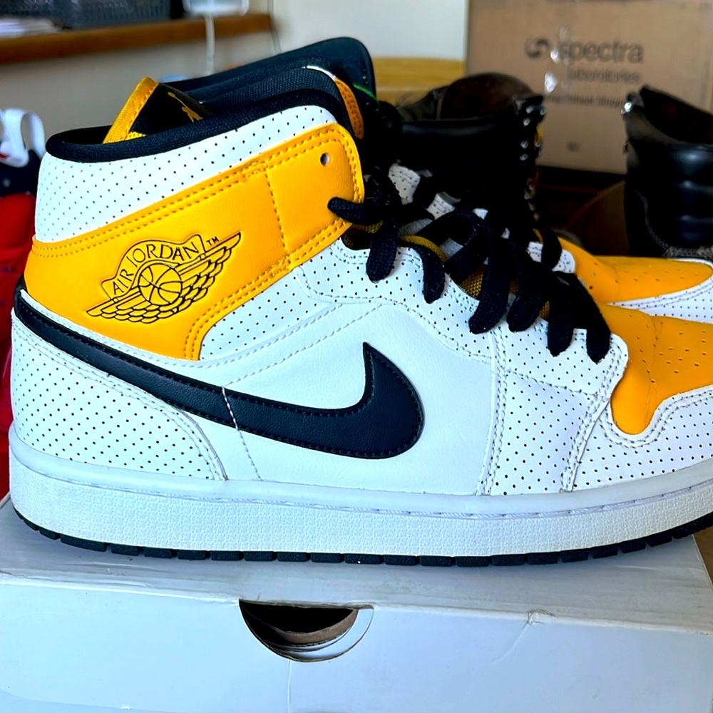 Women’s Air Jordan, one mid white, black and UNIVERSITY gold